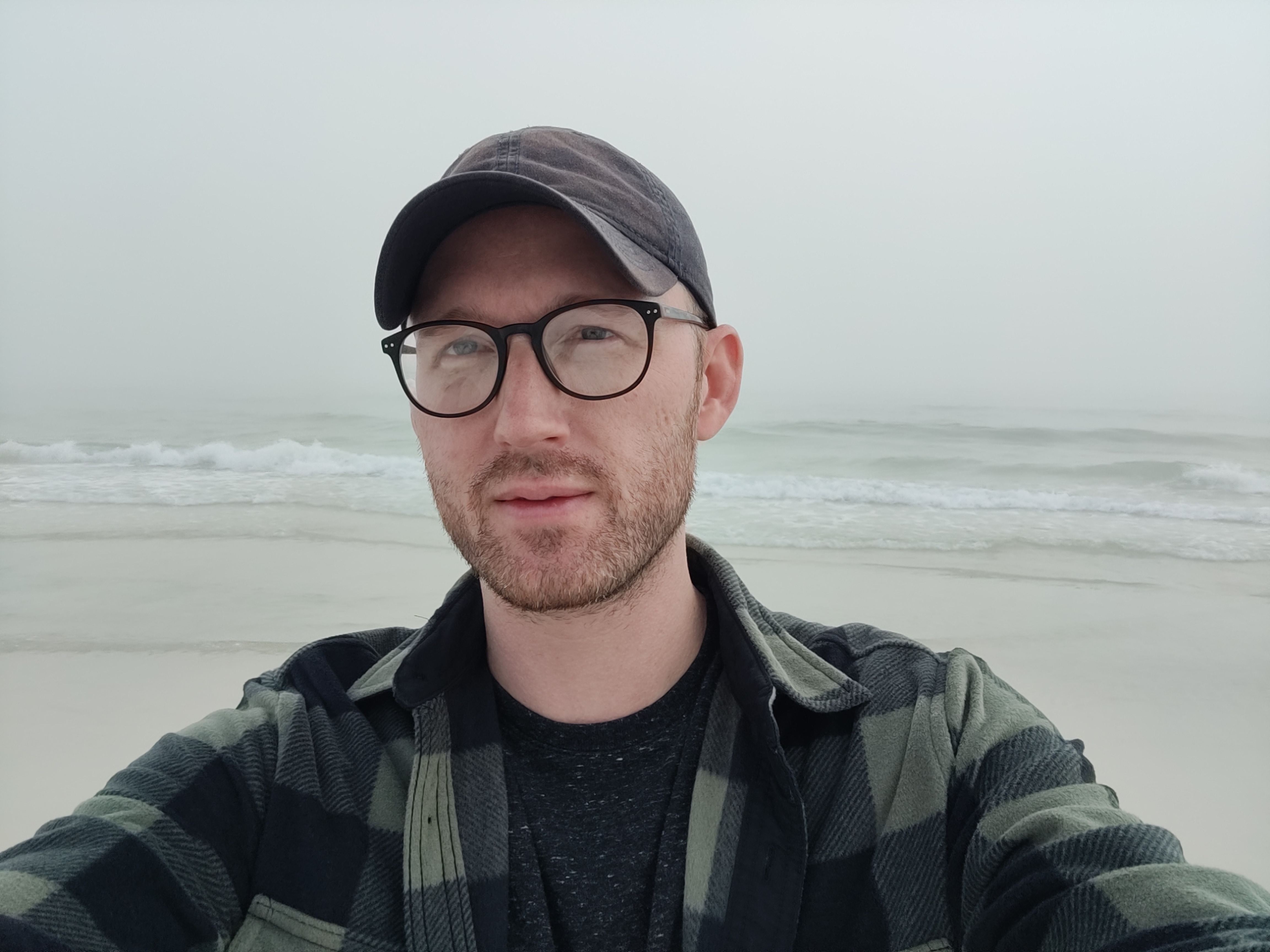 a photograph of David at the beach on a cloudy day